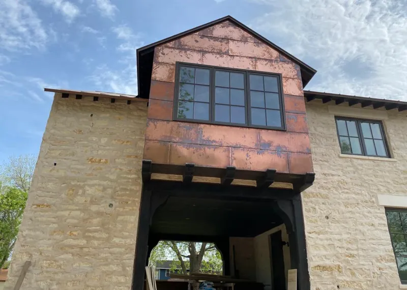 Copper metal panel facade on a stone building for Metal Roof Coating in Boaz