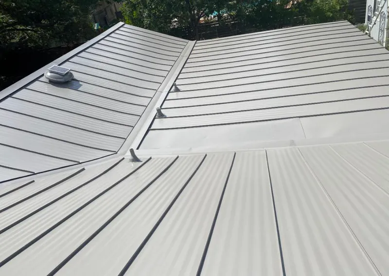 Solar attic fan installed on a metal roof for Roof Ventilation in Boaz